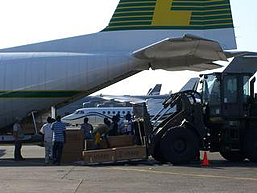 Haiti relief flights - Haiti locals helping to unload Herc