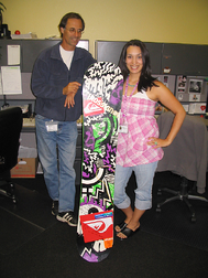 Lynden’s Greg Popadiuk and Amanda Zeppenfeld with the gift from the French Olympic Snowboard Team, a signed Mathieu Crepel snowboard.