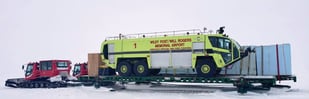Snow cat towing fire truck on North Slope